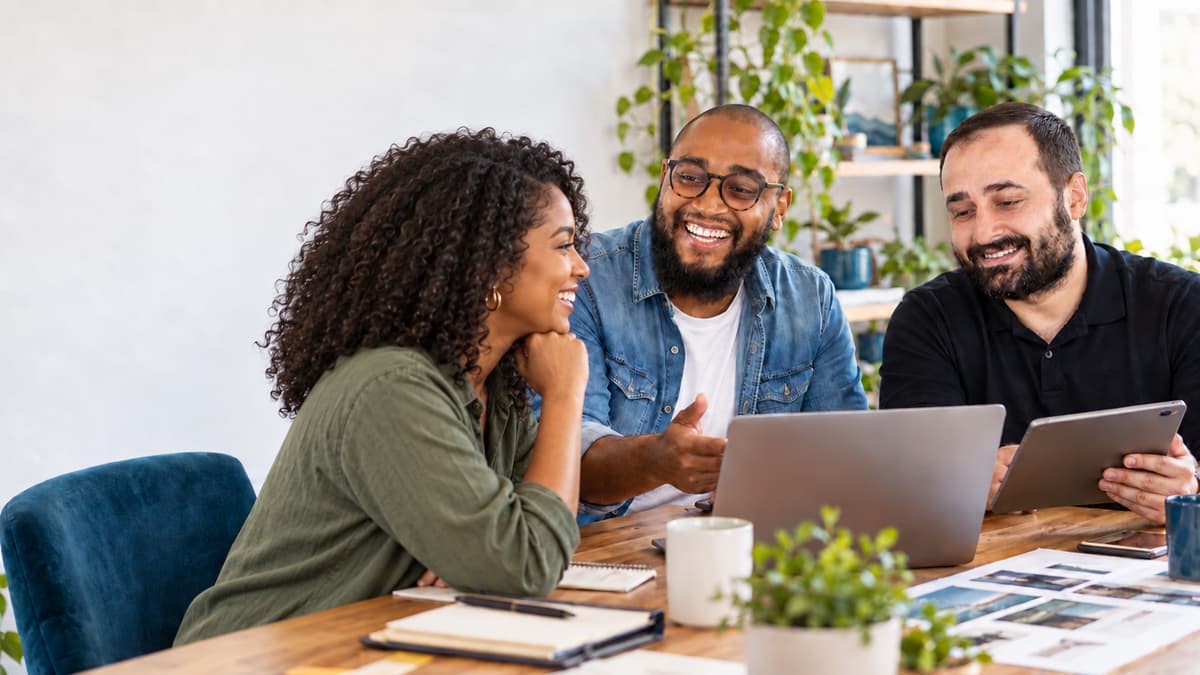 A Contrast teammate talking through a website with a client at a shared table