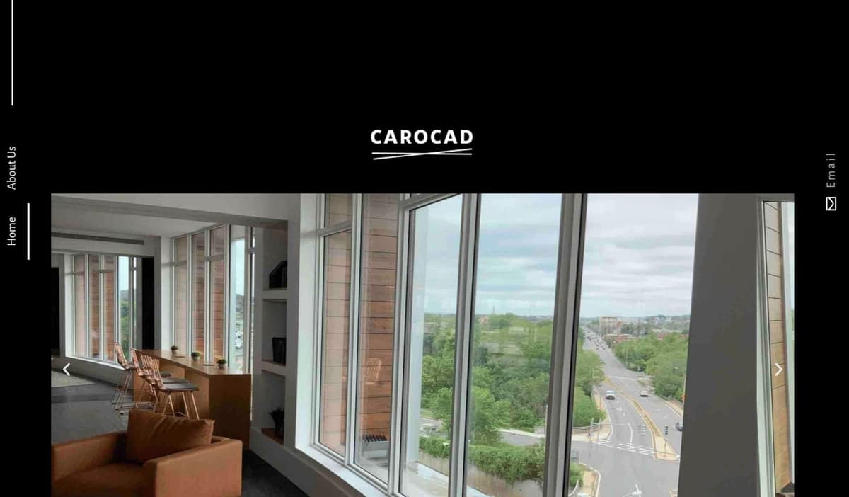 The Carocad website home page: the Carocad wordmark on black above a photo of an office with floor-to-ceiling windows overlooking a city street